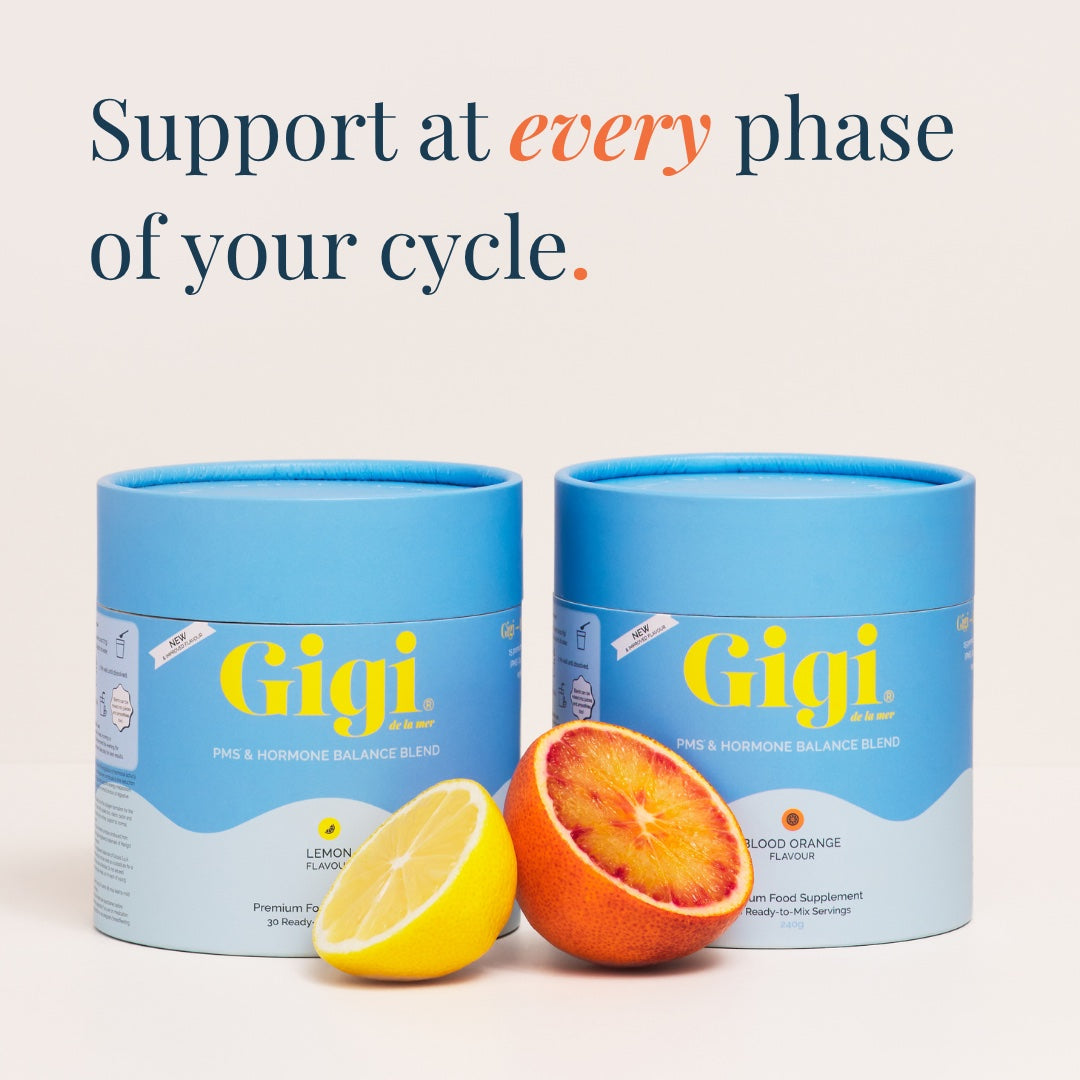 Two Gigi PMS & Hormone Balance Blend tubs, Lemon and Blood Orange, with fresh citrus halves
