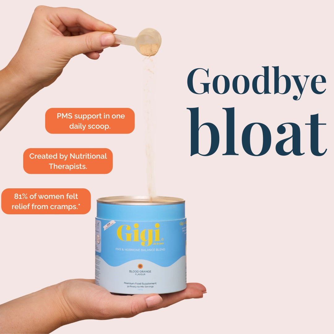 Hand pouring a scoop of Gigi Blood Orange powder into the tub beside a Goodbye Bloat headline