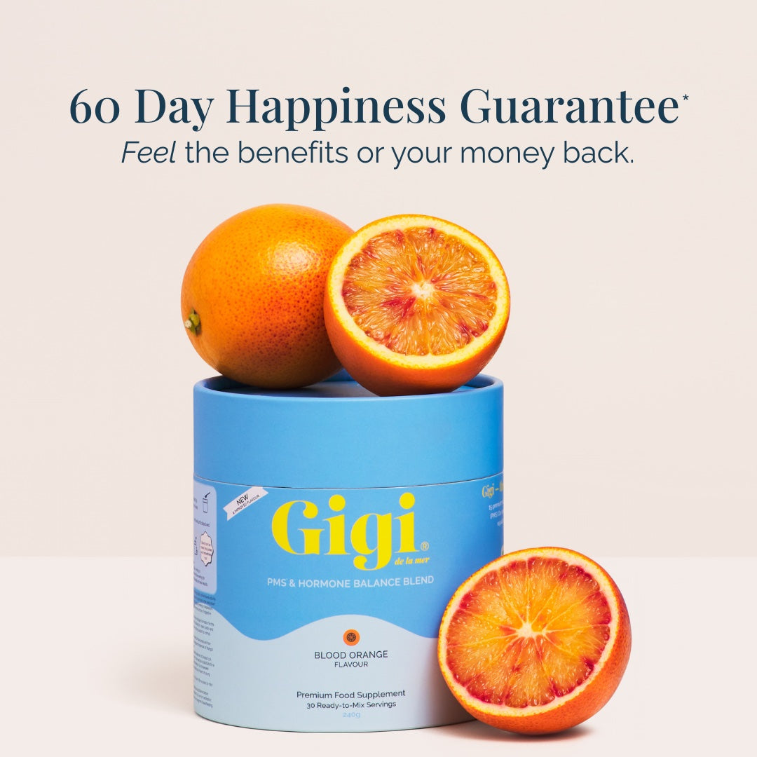 Whole and halved blood oranges on a Gigi Blood Orange tub beside a 60 day happiness guarantee