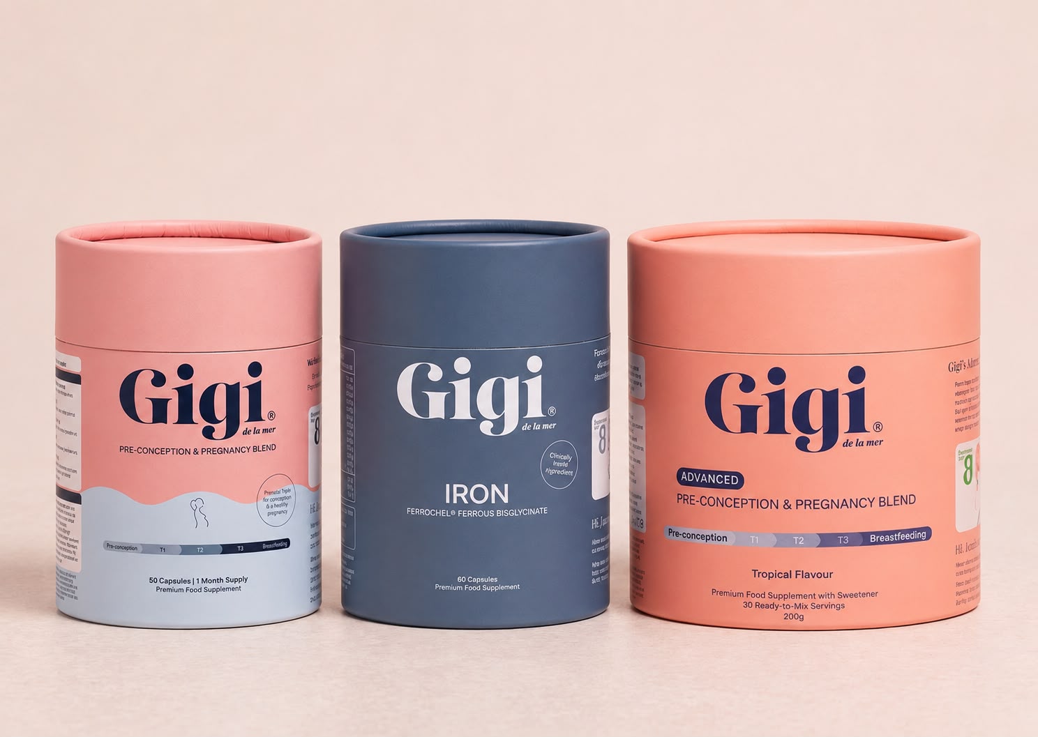 Three Gigi de la mer tubs — Pre-Conception & Pregnancy Blend, Iron and Advanced Pre-Conception & Pregnancy Blend — on a blush background.